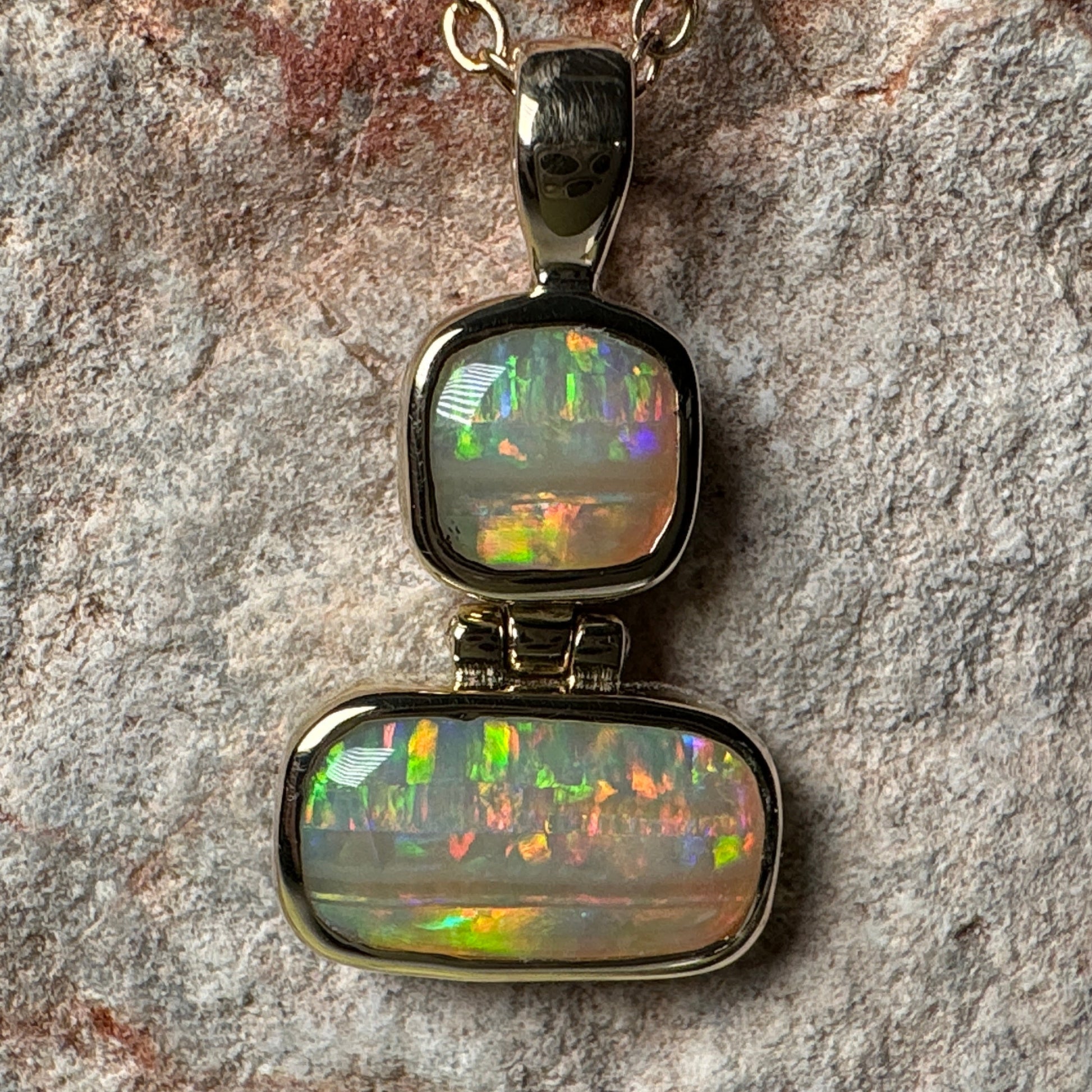 Opal pendant on a stone background